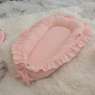 nid-bébé-rose-réducteur-de-lit